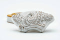 Overhead view of the kogo lid showing a sculpted white bird design accented with gold.