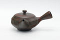 View showing the lid knob, spout, and side handle of the faceted teapot.