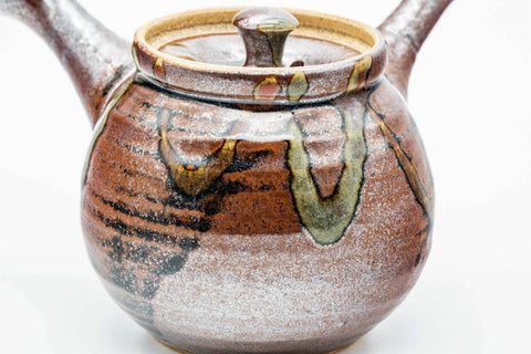 Front view showing the flared spout and drip glaze, lid on.