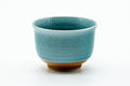 The cup from another angle, showing the crackled celadon glaze.