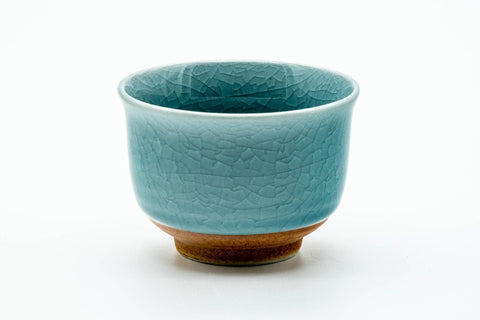 The cup from another angle, showing the crackled celadon glaze.