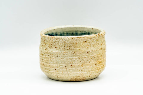 Front view tilted slightly forward to reveal the mottled blue-green interior glaze inside the cup.