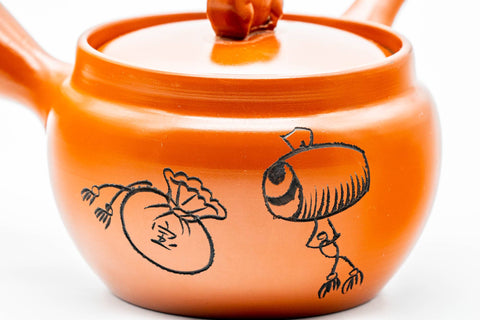 Japanese Kyusu - Sheep Drum Decorated Tokoname-yaki Mesh Teapot - 260ml - side view showing the engraved sheep and drum decoration on the body