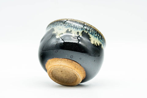 Japanese Teacup - Jet Black Beige Drip-Glazed Guinomi - 40ml - tilted to show the footring