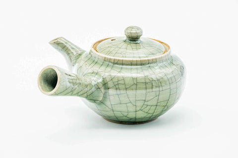Green celadon Obori Soma kyusu, three-quarter view with the spout to the right and handle to the left