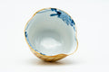 Looking down into a cup, revealing the blue and white floral interior glaze