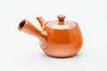 Red shudei Tokoname kyusu, side profile with the spout to the left