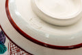 Close-up of the base showing the red rim line and maker's mark