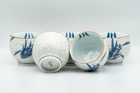Tezumi — Japanese Tea Set - Blue Floral White Matte Glazed Arita-yaki Debeso Kyusu Teapot and 5 Yunomi Teacups — closeup of a single piece