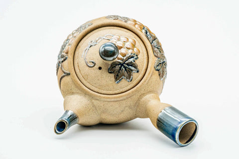 Overhead view of the kyusu, lid on, showing the grapevine motif.