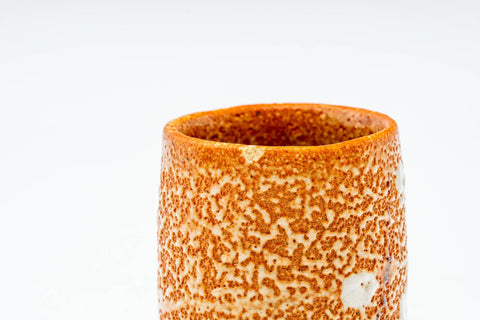 Top-down view into the cup showing the orange glazed interior.