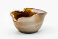 Three-quarter view of the wavy-rimmed katakuchi with its pouring lip.