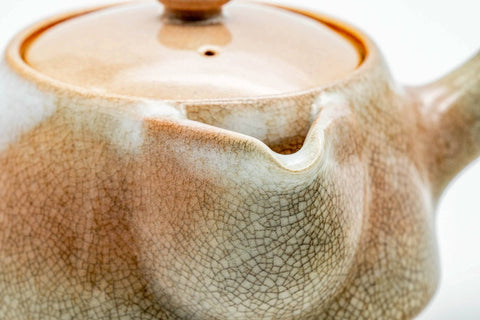 Closeup of the spout base and weathered pink-beige glaze transition on the Hagi-yaki kyusu