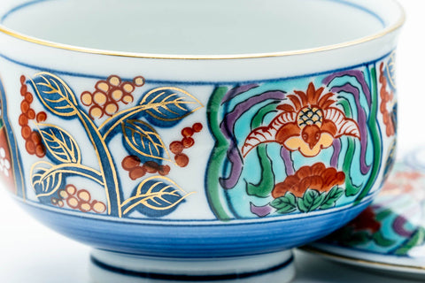 Close-up of the floral band with red, green and gold motifs over a blue ground.