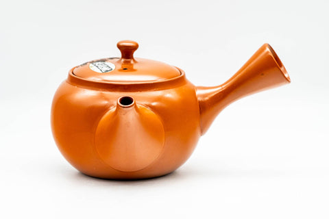 Opposite three-quarter view of the red shudei teapot with the side handle to the left.