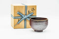 Bizen-yaki matcha chawan with an ash-gradient glaze and spiral throwing rings, shown beside its signed wooden box