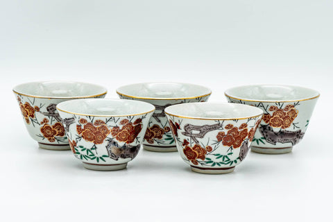 The five matching yunomi teacups arranged in a row, showing their floral exteriors.