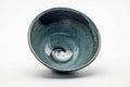 Tilted view into the bowl highlighting the swirling glaze and rim.