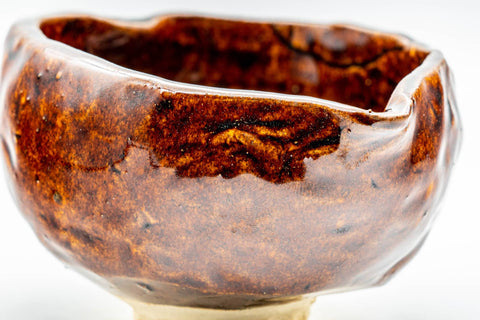 Close-up interior view of the dark glossy glaze pooling inside the katakuchi