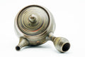 Overhead view of the domed lid and knob, with concentric carved rings.