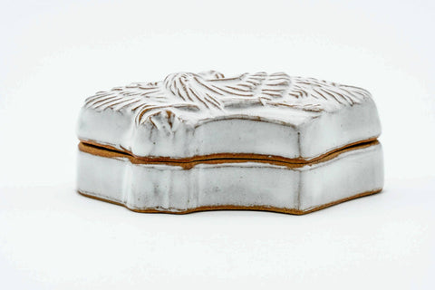 Front view of the closed bird-form kogo in white glaze with a gold-lined rim.