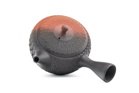 Black-and-red yōhen Tokoname kyusu teapot with side handle and dimpled tochiri texture - overhead view of the lid and side handle