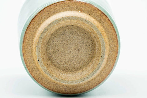Underside of the teacup, showing the unglazed clay foot ring.