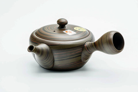 Dark green nerikomi Tokoname kyusu, front view with the spout pointing left and the lid seated