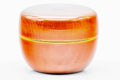 Close-up of the closed orange ko-natsume showing the glossy amber lacquer and gold band detail.