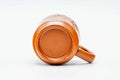 The cup tilted on its side, showing the foot and the handle.