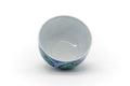Overhead view into the open teacup showing the white interior and blue rim line.