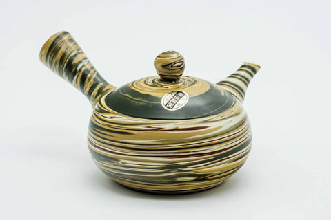 Another angle highlighting the handle and the marbled clay pattern.