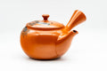 Front view of the glossy red shudei teapot showing the spout and side handle.