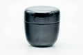 Glossy black-urushi matcha tea caddy, lid on, front view of the domed lid