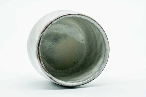 Teacup tilted to show the glazed interior and rim.