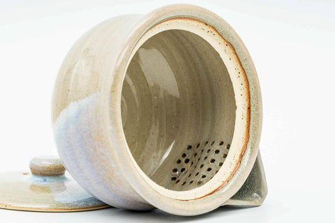 Overhead view into the houhin showing the perforated built-in strainer.