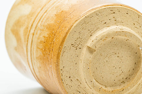 Close-up of the unglazed foot showing concentric throwing rings.