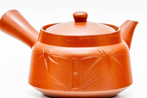 Teapot seen from the back, lid on, showing the smooth red clay body