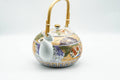 Japanese Tea Set - Floral Arita-yaki Dobin Teapot with 3 Lidded Yunomi Teacups - side view of the dobin teapot