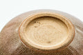 Underside of the beige-pink Hagi-yaki kyusu showing the unglazed clay foot ring