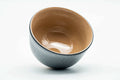 Interior of the matcha bowl, tilted to show the smooth beige glazed inside and the curve of the well.