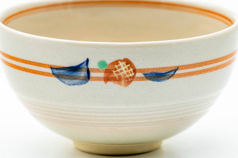 Close-up of one cup showing the orange stripe bands and a small painted motif.