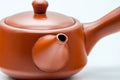 Japanese Kyusu - Smooth Red Shudei Tokoname-yaki Ceramic Filter Teapot - 300ml - three-quarter view showing the spout and handle junction