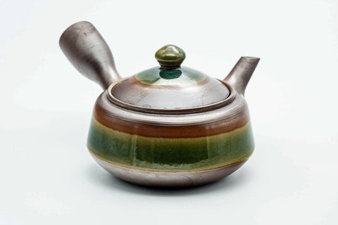Three-quarter view of the green-glazed banko kyusu with the lid on.