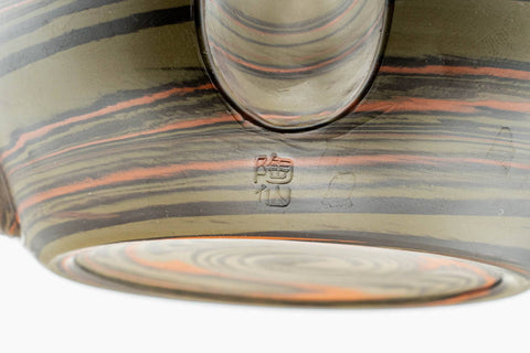 Closeup of the marbled nerikomi striping on the body and spout base of the dark green Tokoname kyusu