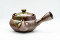 Banko-yaki side-handle kyusu teapot with an iridescent ash-green and purple glaze, three-quarter front view with lid and side handle.