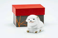 White Kyo-yaki kogo (incense container) modelled as a seated puppy, shown beside its red lidded box.
