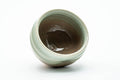 The cup tipped to reveal the glazed interior.