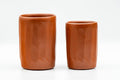 Japanese Teacups - Pair of Carved Red Shudei Tokoname-yaki Meoto Yunomi - the two carved red clay cups side by side, one taller and one shorter