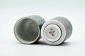 The cups with lids off, showing the interiors and the undersides of the lids.